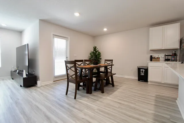 a bedroom with a bed and a flat tv screen on wall
