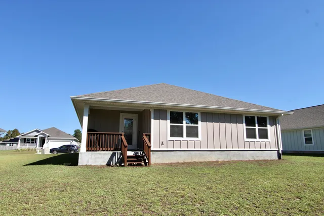a view of a house with backyard porch and furniture