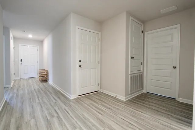 a view of hallway with wooden floor