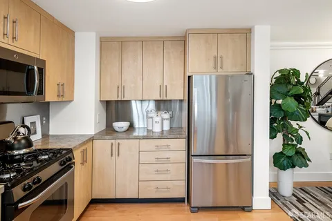 a kitchen with stainless steel appliances a refrigerator a stove a microwave and cabinets