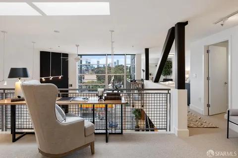 a view of living room with furniture and large window