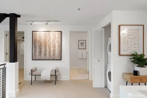 a spacious bedroom with a bed and a chair