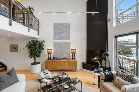 a living room with furniture and a potted plant
