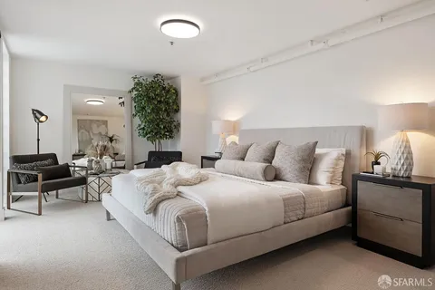 a bedroom with bed and a potted plant