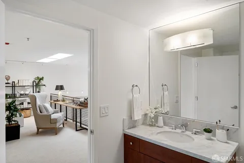 a en suite bathroom with a double vanity sink and a mirror