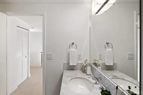 a bathroom with double vanity sink and a mirror