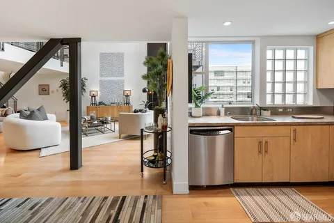 a kitchen with stainless steel appliances granite countertop a sink stove and wooden floor
