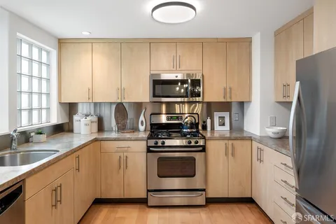 a kitchen with a sink stove and refrigerator