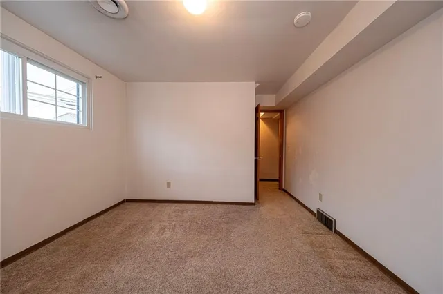 a view of an empty room with windows