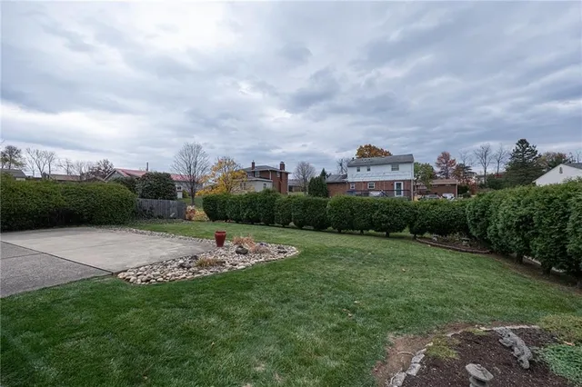 a view of a garden with a building in the background
