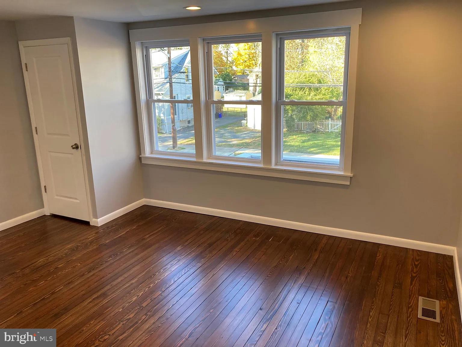 28 Locust Street Merchantville, NJ 08109 - Photo 5 of 10 a view of an empty room with wooden floor and a window