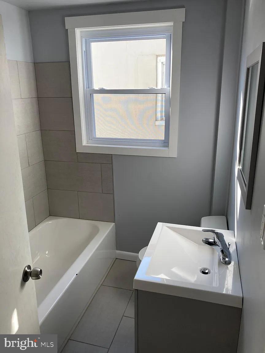 28 Locust Street Merchantville, NJ 08109 - Photo 7 of 10 a bathroom with a sink a bathtub and a window