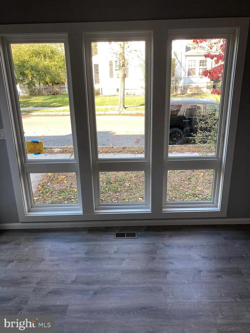 28 Locust Street Merchantville, NJ 08109 - Photo 8 of 10 a view of empty room with wooden floor and fan