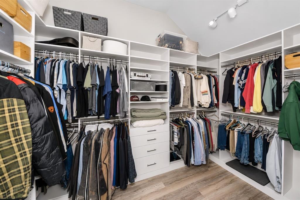 3817 Ganzer Road West Denton, TX 76207 - Photo 30 of 40 The custom walk-in closet offers generous hanging space, built-in shelving, and dedicated winter storage along the upper sections, keeping everything organized and easy to reach. Bright lighting and a thoughtful layout make the space feel open and functional, with room for clothing, linens, and seasonal items. It’s a well-designed storage area that adds everyday convenience to the primary suite.