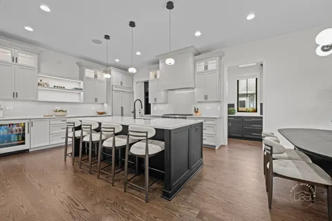 a large kitchen with a table and chairs