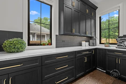 a kitchen with a sink cabinets and window