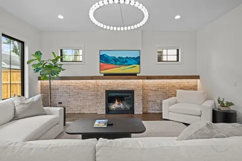 a living room with furniture a fireplace and a table