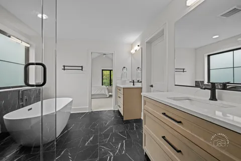 a large kitchen with kitchen island a counter top space a sink stainless steel appliances and cabinets