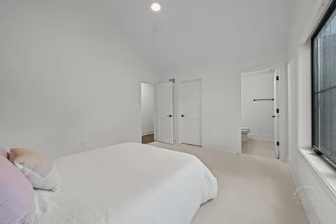 a view of a bedroom with a bed and a tv