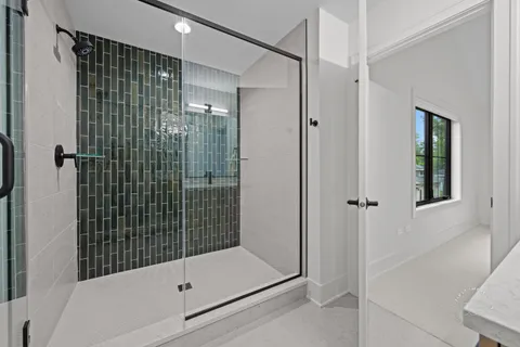a bathroom with a shower and a sink