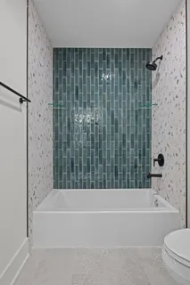 a bathroom with a bathtub and a shower
