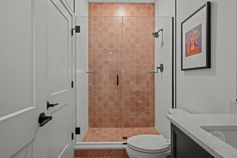 a bathroom with a toilet and a shower