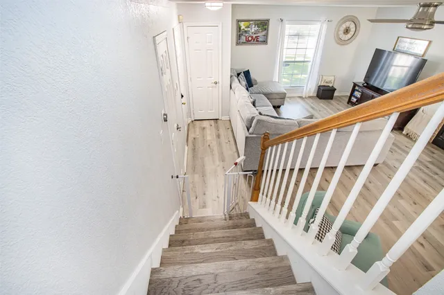 a kitchen with kitchen island granite countertop wooden floors and stainless steel appliances