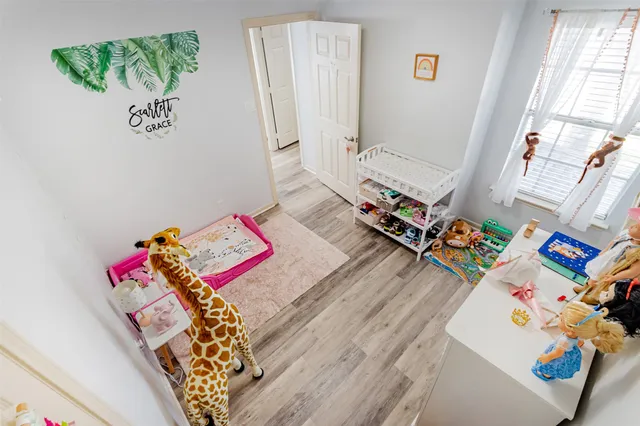 a bed sitting in a bedroom next to a window