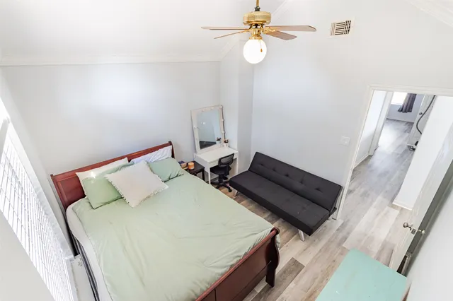 a view of an empty room with wooden floor