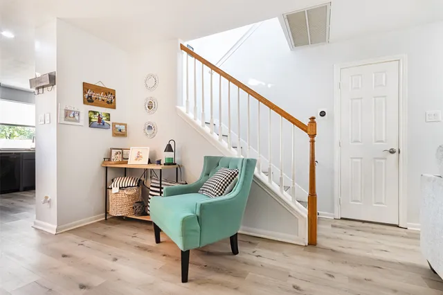 a view of a hallway with stairs and furniture