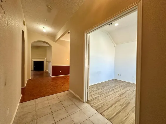 a view of a hallway with wooden shelves