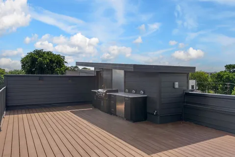 a large kitchen with stainless steel appliances kitchen island granite countertop a large counter top and stove