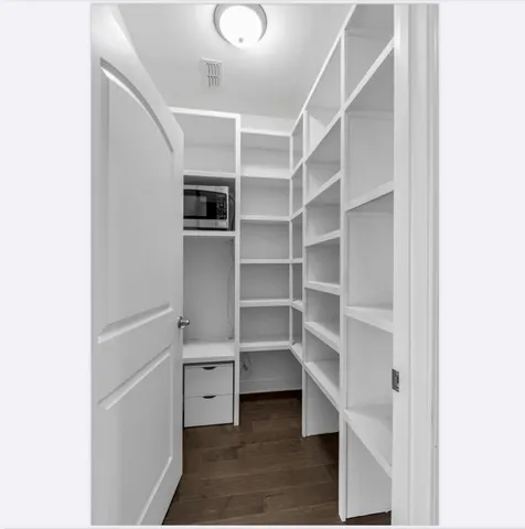 an empty room with windows and ceiling fan view