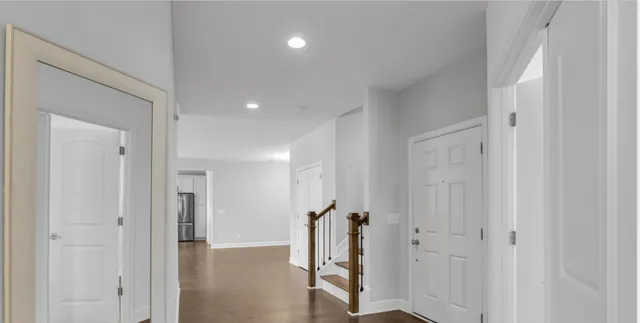 a kitchen with stainless steel appliances granite countertop a sink a stove and a refrigerator