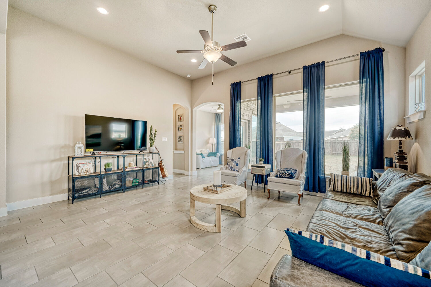 3317 Nighthawk Dive Lane Pflugerville, TX 78660 - Photo 12 of 34 Living room with high ceilings and large windows.