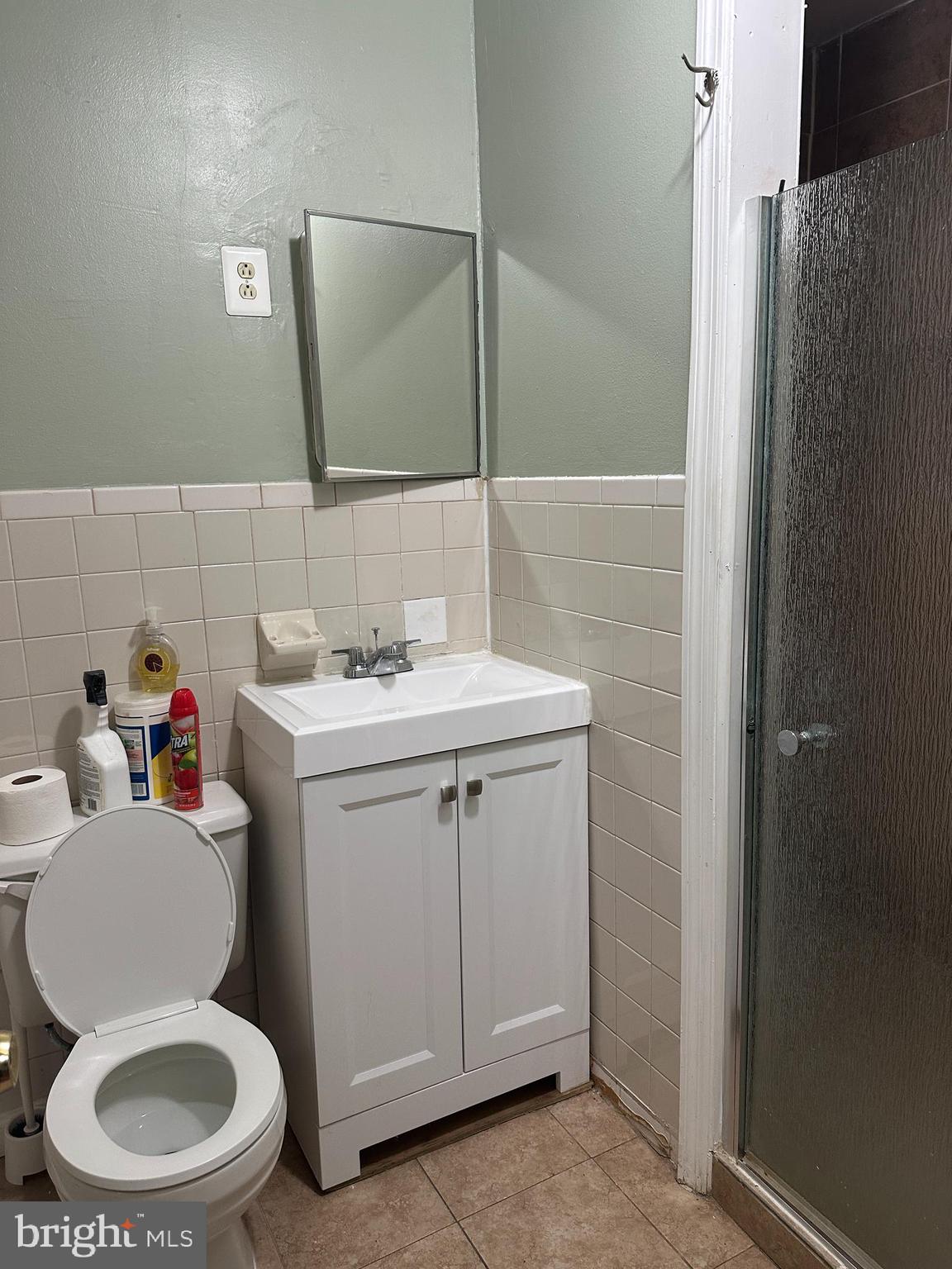 8411 11th Avenue Silver Spring, MD 20903 - Photo 24 of 24 a bathroom with a toilet sink and mirror