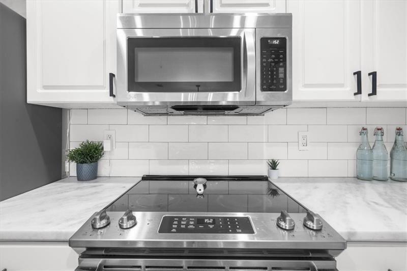 3475 Oak Valley Road Northeast, Unit 410 Atlanta, GA 30326 - Photo 7 of 36 a stove top oven sitting inside of a kitchen