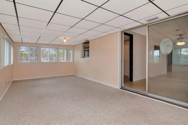 a view of empty room with floor to ceiling windows