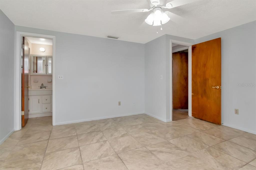 349 Old Welcome Road Lithia, FL 33547 - Photo 22 of 54 a view of an empty room with window and chandelier fan