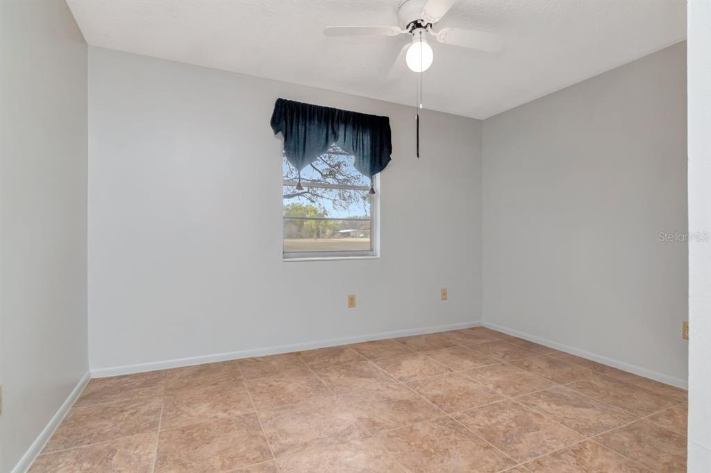 349 Old Welcome Road Lithia, FL 33547 - Photo 28 of 54 an empty room with windows and fan