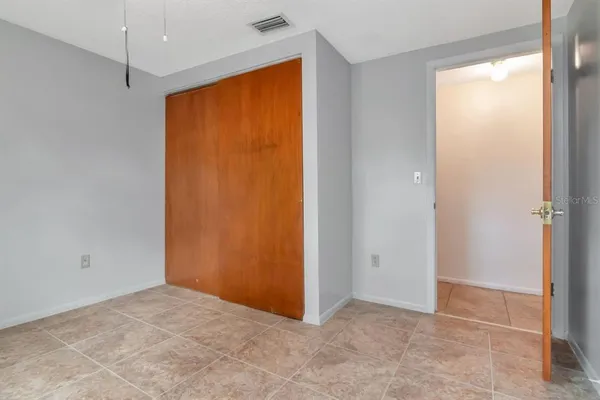 an empty room with closet area
