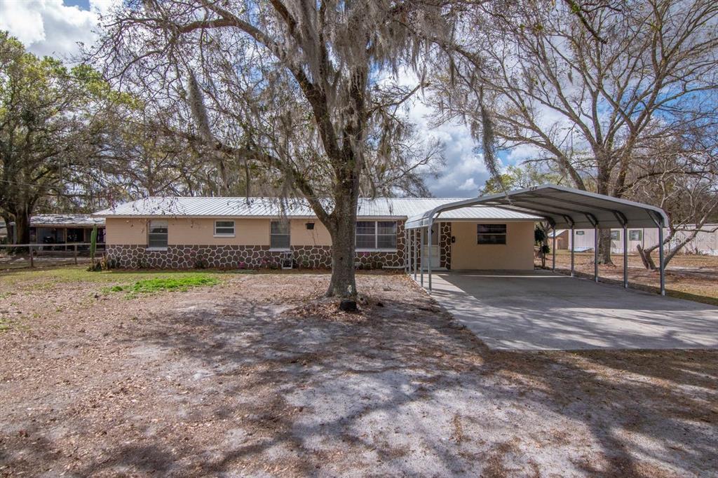 349 Old Welcome Road Lithia, FL 33547 - Photo 45 of 54 a front view of a house with a yard
