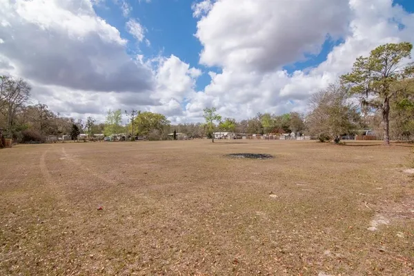 a backyard of a house with large trees