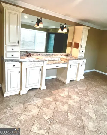 a view of a kitchen with a sink and cabinets