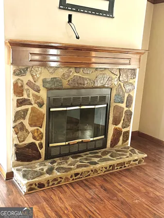 a living room with a fireplace and a rug