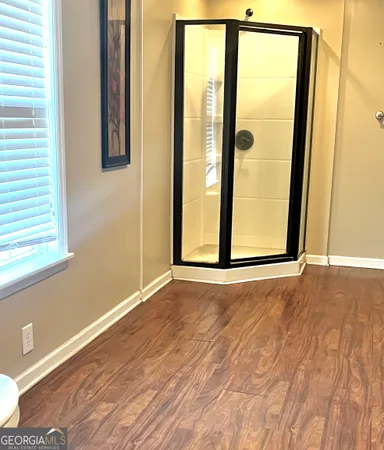 a view of a room with wooden floor and windows