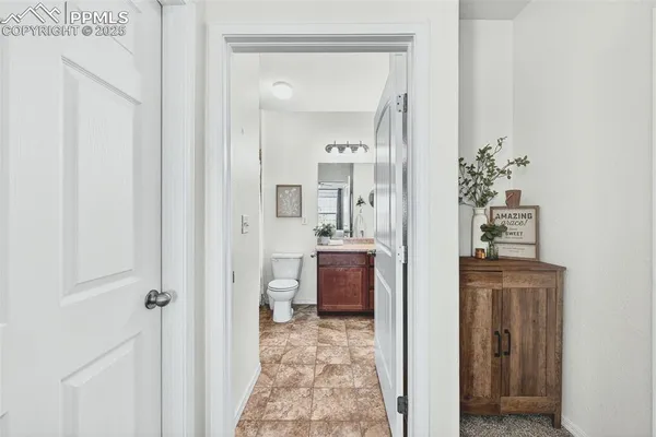 a bathroom with a sink mirror vanity and toilet