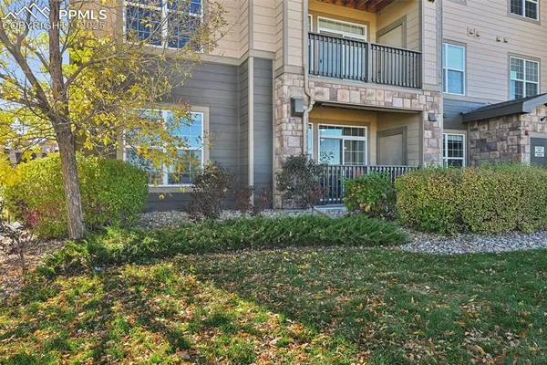 front view of a brick house with a yard