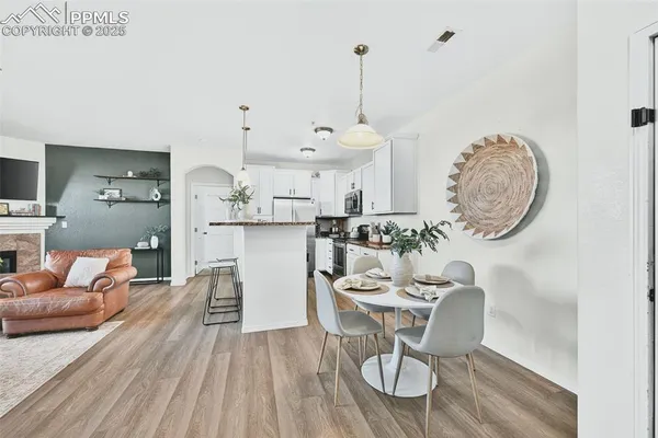 a kitchen with stainless steel appliances granite countertop a sink a refrigerator and a granite counter tops