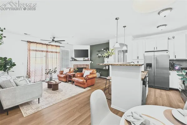 a living room with furniture and kitchen view